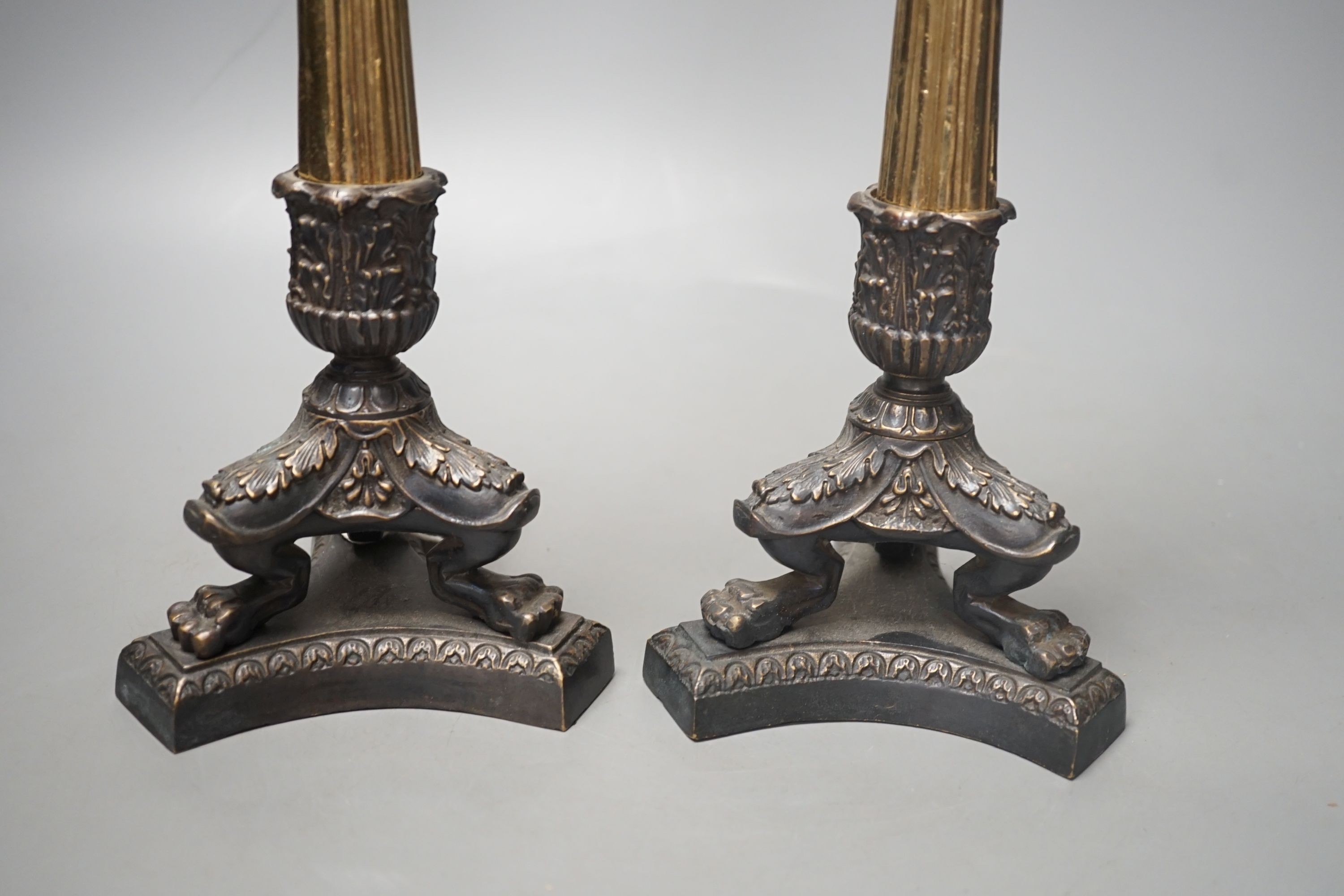 A pair of neo-classical style brass candlesticks, 28.5 cms high.